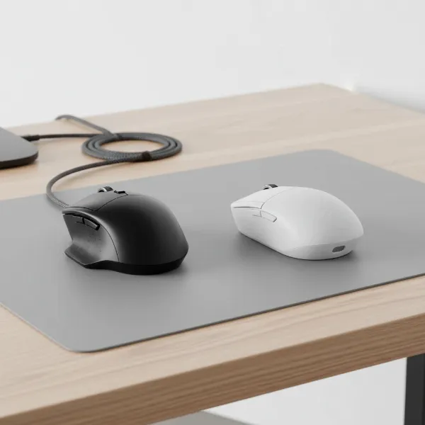 Comparison image of a wired and a wireless computer mouse on a desktop, highlighting connectivity.